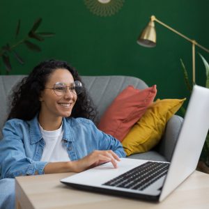 young-beautiful-female-student-studying-remotely-online-using-laptop-latin-american-woman-sitting-1-scaled.jpg